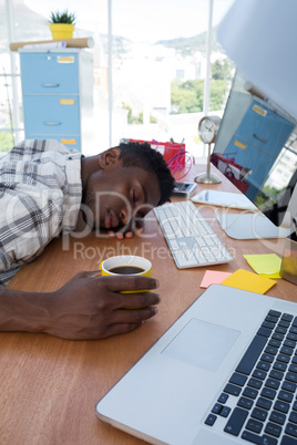 Male executive resting at his desk