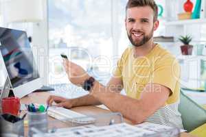 Male executive doing online shopping on computer at desk