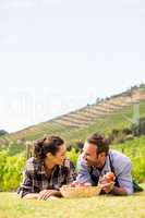Couple with apple basket relaxing at vineyard