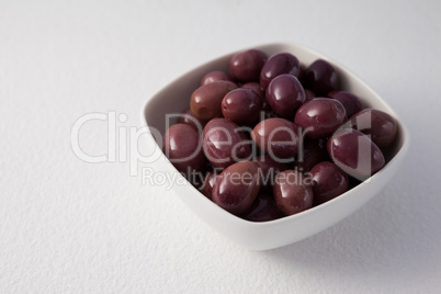 Close up of brown olives in container