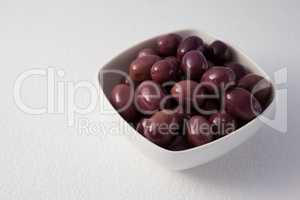 Close up of brown olives in container
