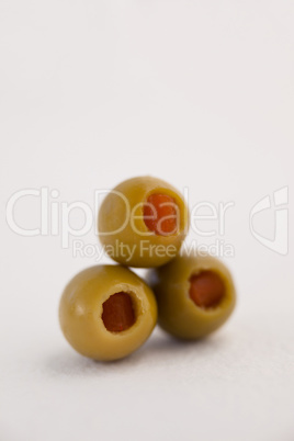 Close up of green olives arranged on table