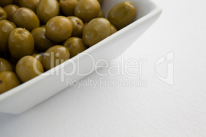 Close up of green olives in container