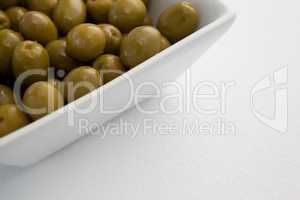 Close up of green olives in container