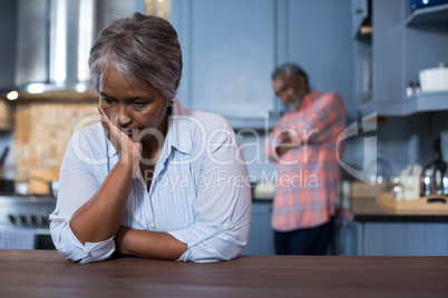 Sad woman with man in background