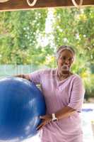 Portrait of smiling woman holding fitness ball