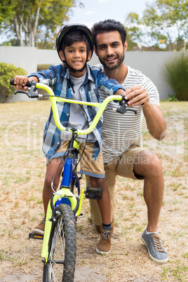 Portrait of father and son in yard