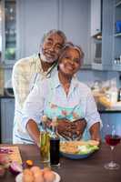 Portriat of smiling senior couple preparing food