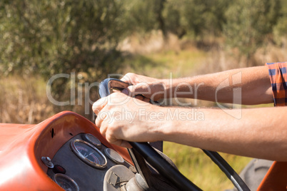 Close-up of man driving tractor in olive farm