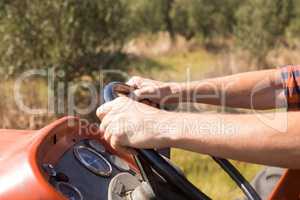 Close-up of man driving tractor in olive farm