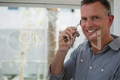 Portrait of smiling designer talking on microphone