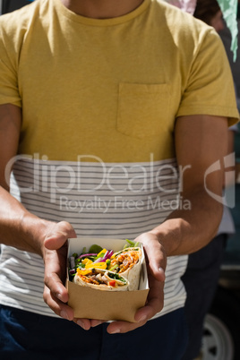 Man holding tortilla in box