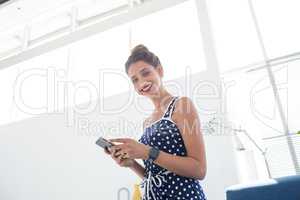 Female executive using mobile phone in the office