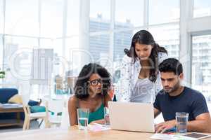 Executives working on laptop in the office