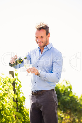 Man pouring wine from bottle in glass