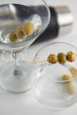 Close up of green olives in vodka martini