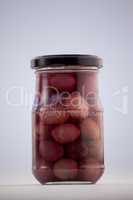 Red olives in glass jar