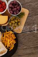 Overhead view of olives with vegetable at table