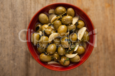 Overhead view of olives with spice and herbs in bowl