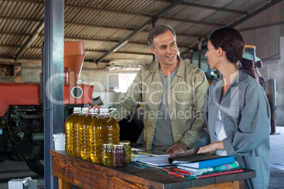 Workers interacting while maintaining record in book