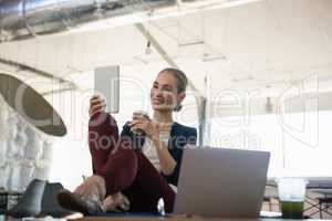 Businesswoman using tablet computer in office