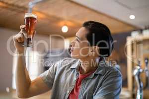 Man looking at beer glass in a restaurant