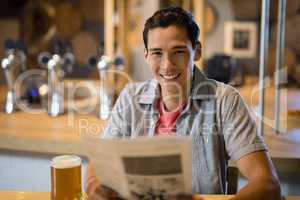 Man holding newspaper in a restaurant