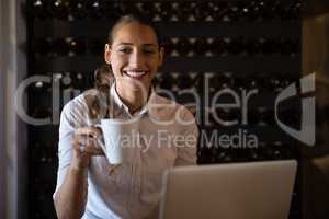 Smiling woman having coffee in cafe