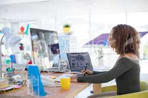 Female graphic designer working at desk