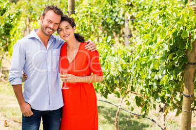 Portrait of couple standing at vineyard