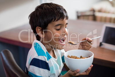 Close up of boy having cereal breakfast