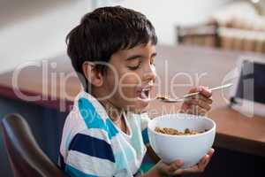 Close up of boy having cereal breakfast