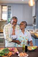 Smiling senior couple preparing food