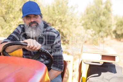 Portrait of confident man sitting in tractor