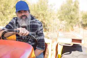 Portrait of confident man sitting in tractor
