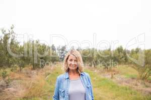 Happy woman standing in olive farm