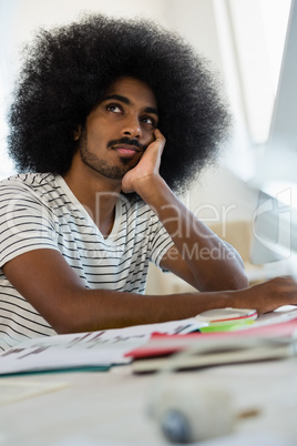 Thoughtful man with curly hair at office