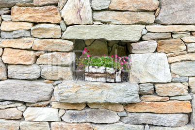 Old stone wall decorated with flowers
