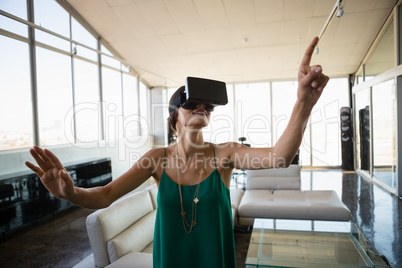 Woman using virtual reality simulator in office