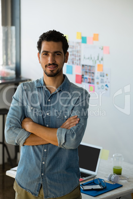 Portrait of businessman with arms crossed at office