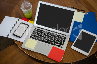 High angle view of laptop and digital tablet on table in office