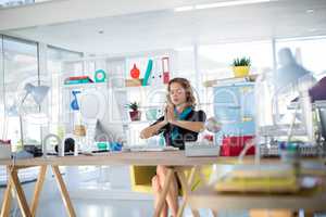 Female executive doing yoga in office