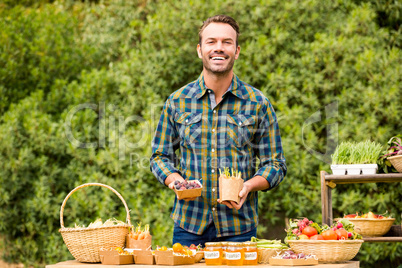 Portrait of handsome man selling organic vegetables