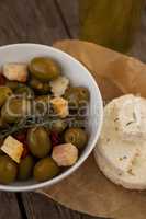 Close up of green olives with cheese on wax paper