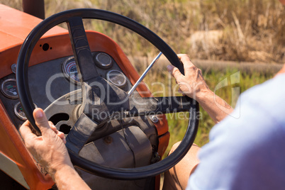 Close-up of woman driving tractor in olive farm