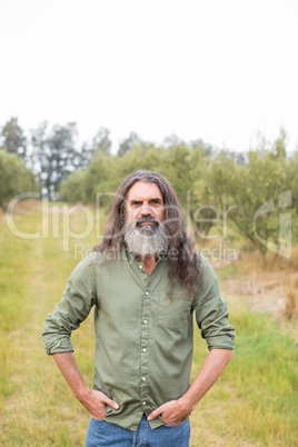 Portrait of confident man standing with hands in pockets