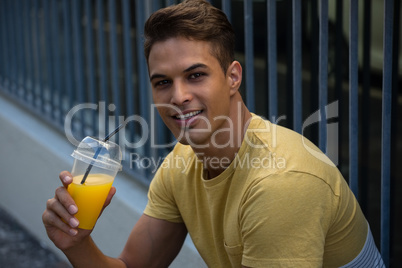 Portrait of smiling man holding juice
