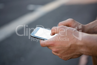 Cropped hands of man using phone