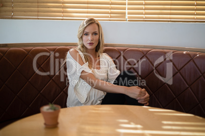 Beautiful woman sitting on sofa in restaurant