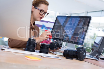 Female executive repairing a digital camera